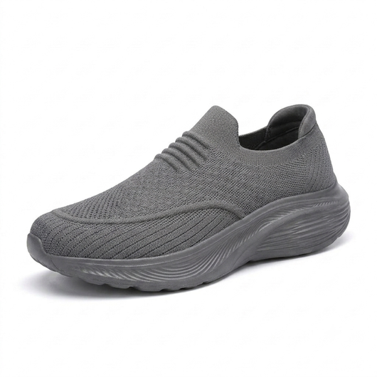 Grå slip-on komfortsko unisex med støtdempende sål og stretchstrikket overdel mot hvit bakgrunn