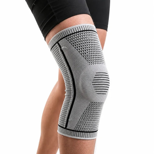 Knestøtte med fjærer i grått, sidevisning på kne